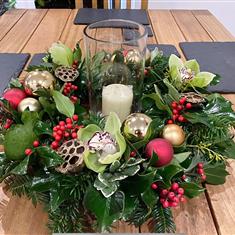 Christmas table display with candle and vase
